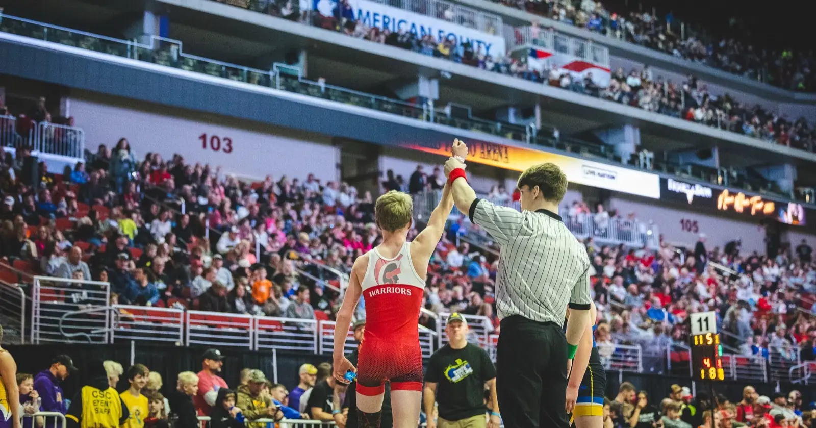 A Little Warrior getting his hand raised at state