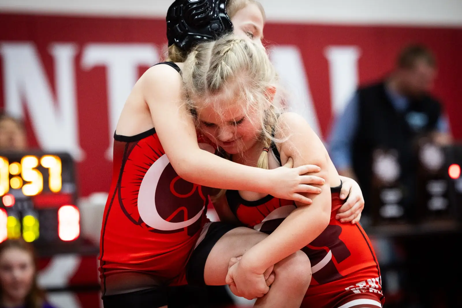 Two young Little Warriors hugging